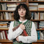 a woman holding a book in a library